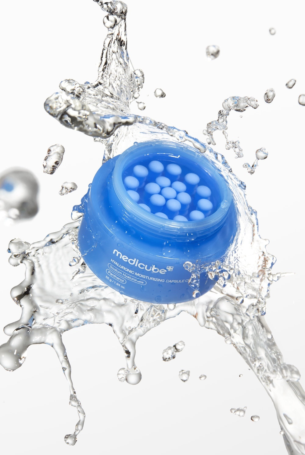 Medicube Hyaluronic Moisturizing Capsule Cream in a clear jar featuring small blue suspended moisture capsules
