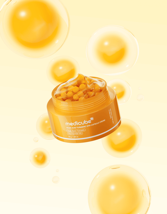Medicube Kojic Acid Turmeric Vita Capsule Cream in a clear jar with yellow vitamin capsules suspended in white cream