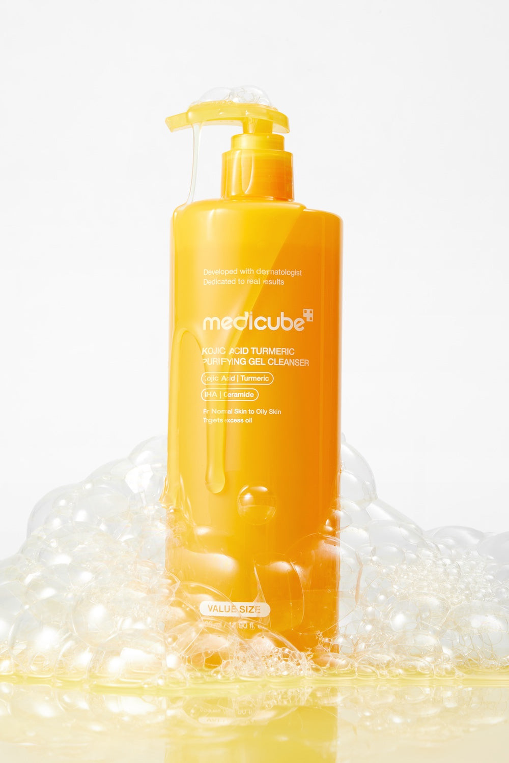 Medicube Kojic Acid Turmeric Gel to Foam Cleanser in a large 500ml pump bottle with bright yellow liquid inside