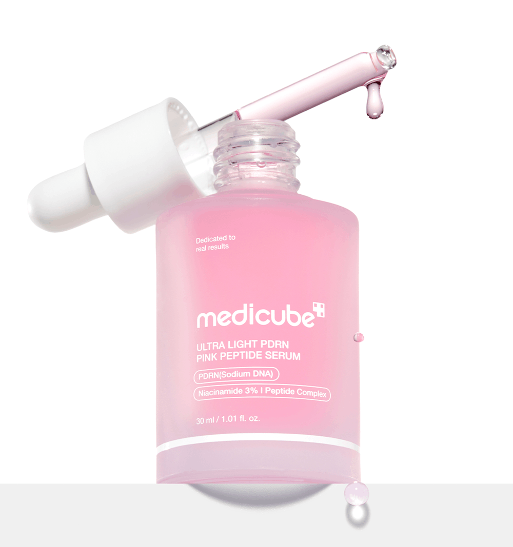Medicube PDRN Pink Peptide Serum Ultra Light in a clear glass bottle with vibrant pink liquid and a silver dropper cap