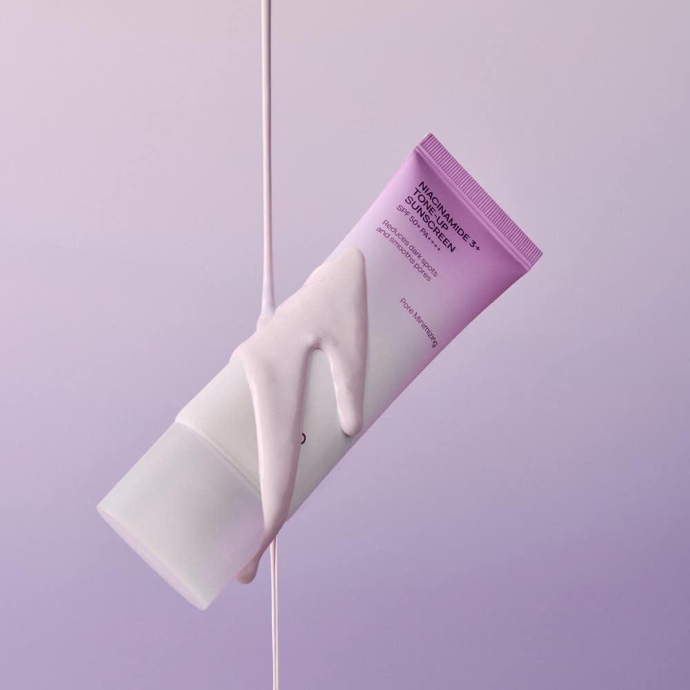 Jumiso Niacinamide 3+ Tone-Up Sunscreen in a white squeeze tube with a bright orange cap and minimalist black text