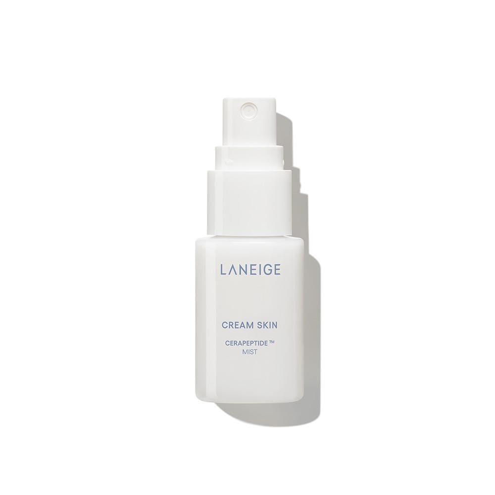 Laneige Cream Skin Cerapeptide Mist in a small clear spray bottle with a white cap and milky liquid formula