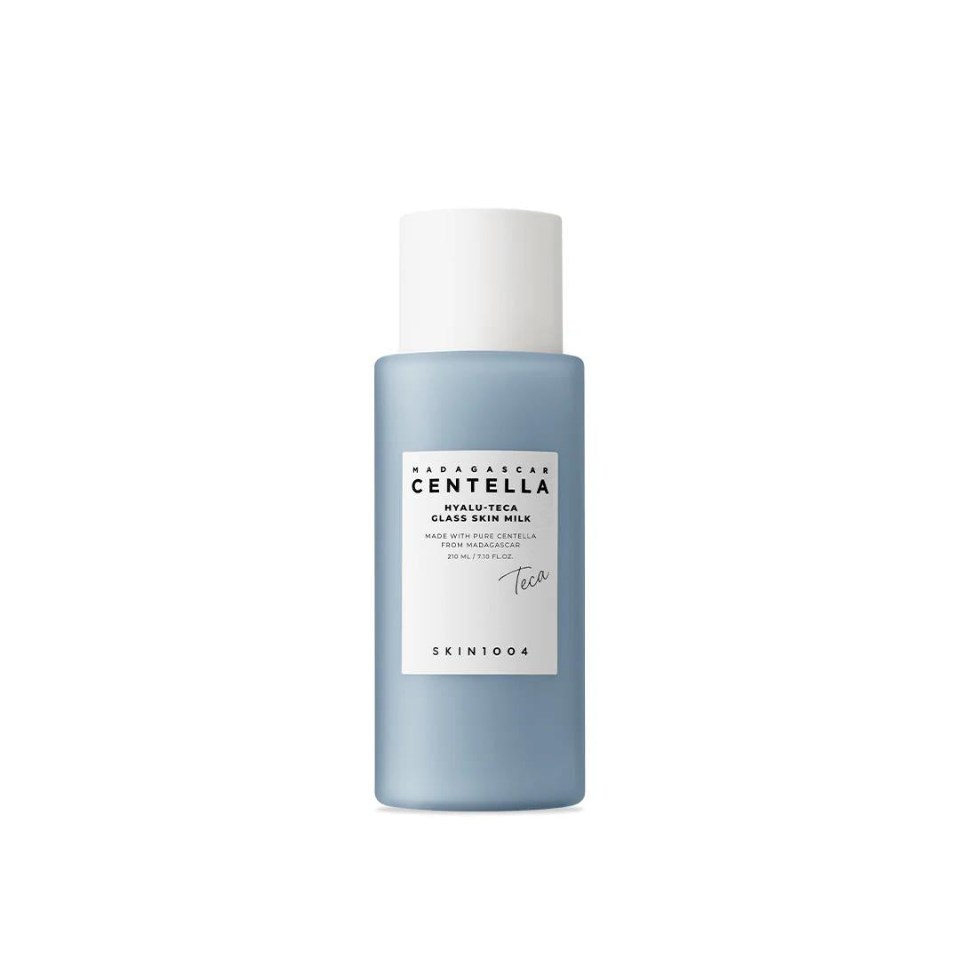 SKIN1004 Madagascar Centella Hyalu-Cica Glass Skin Milk in a tall translucent blue bottle with a white pump dispenser