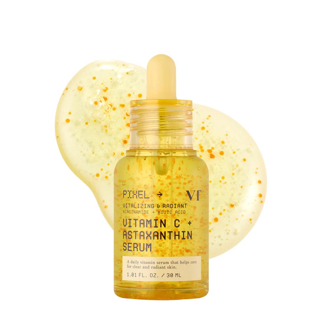 VT Cosmetics Vitamin C+ Astaxanthin Serum in a clear bottle with bright orange liquid and a silver pump cap